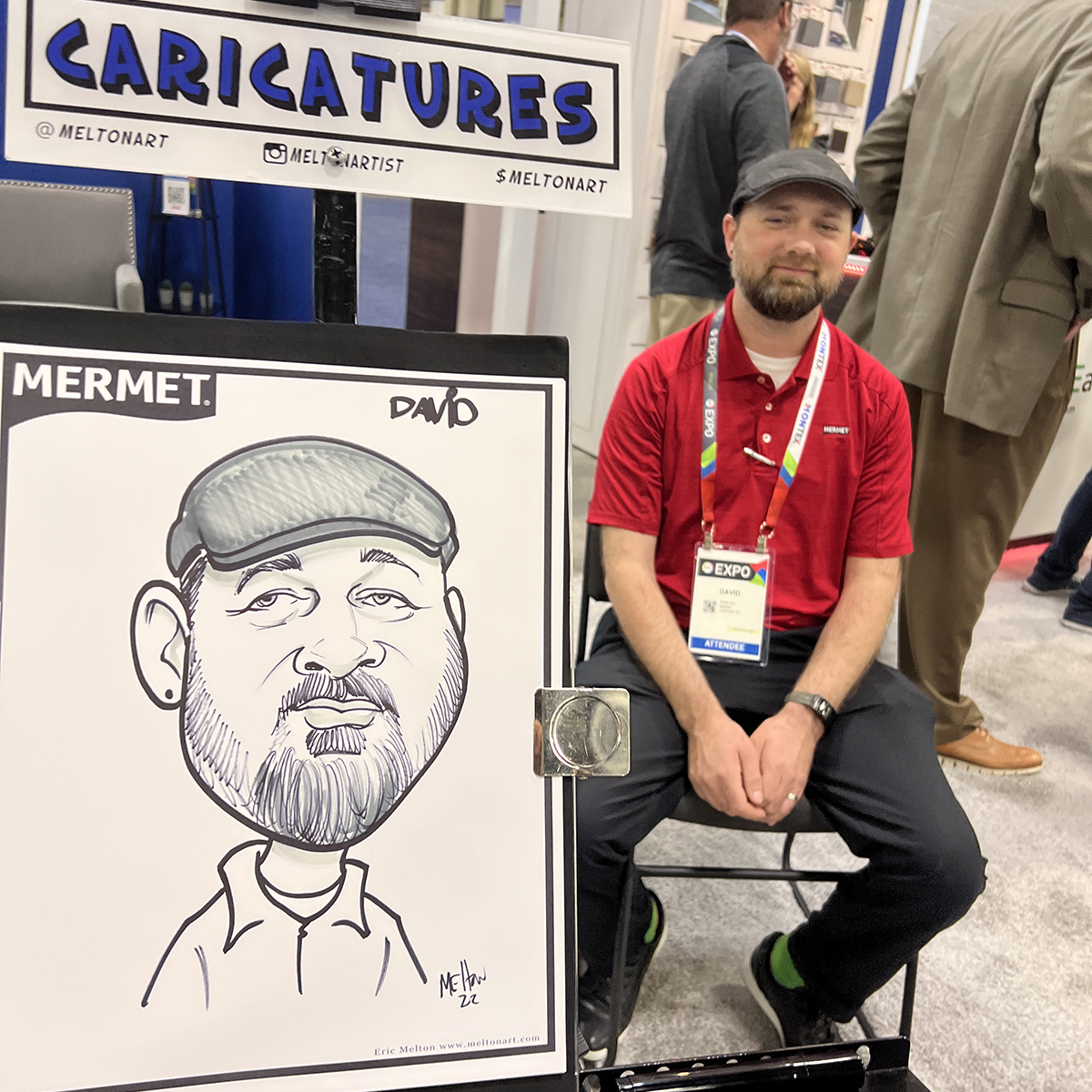 Trade show booth visitor gets drawn by the caricature guy.