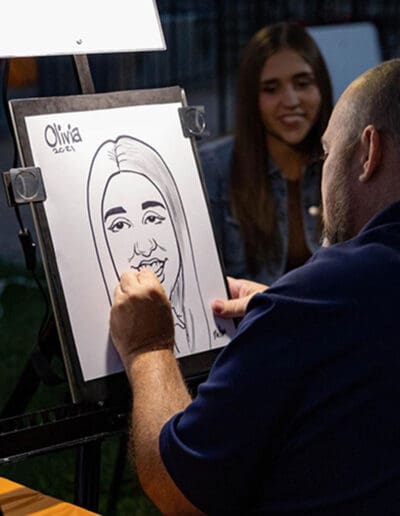 College girl anticipating her sketch by world renowned Caricaturist Eric Melton