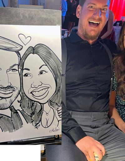 Happy couple getting an original Eric Melton Caricature.