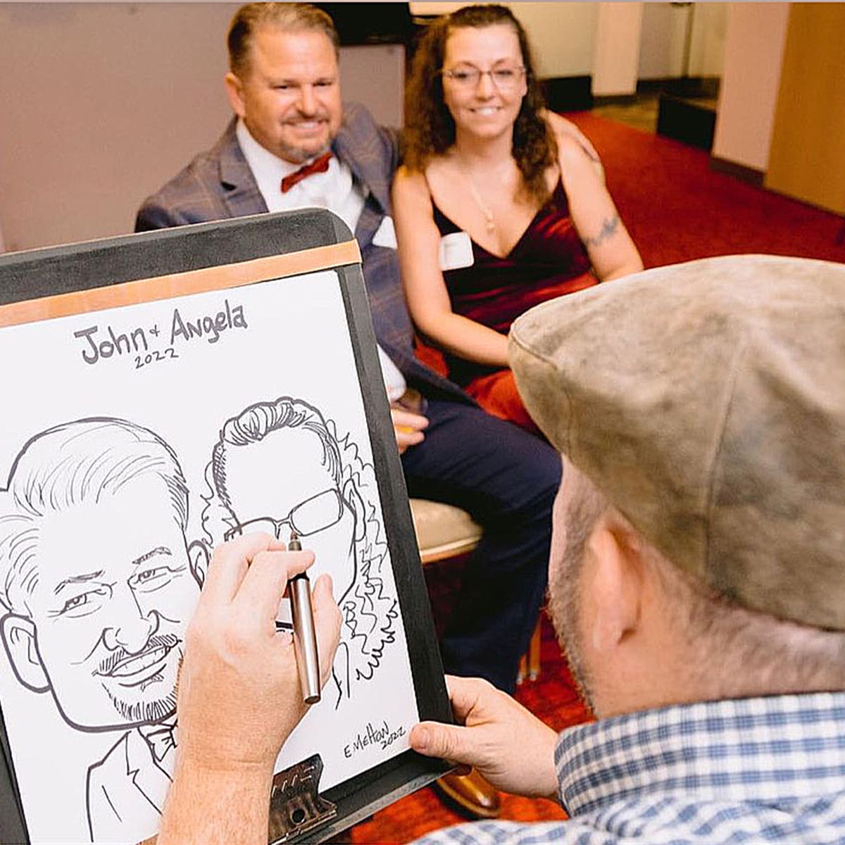 wedding-favors-caricatues-nc (2) Couple having Caricature drawn at a wedding in NC.