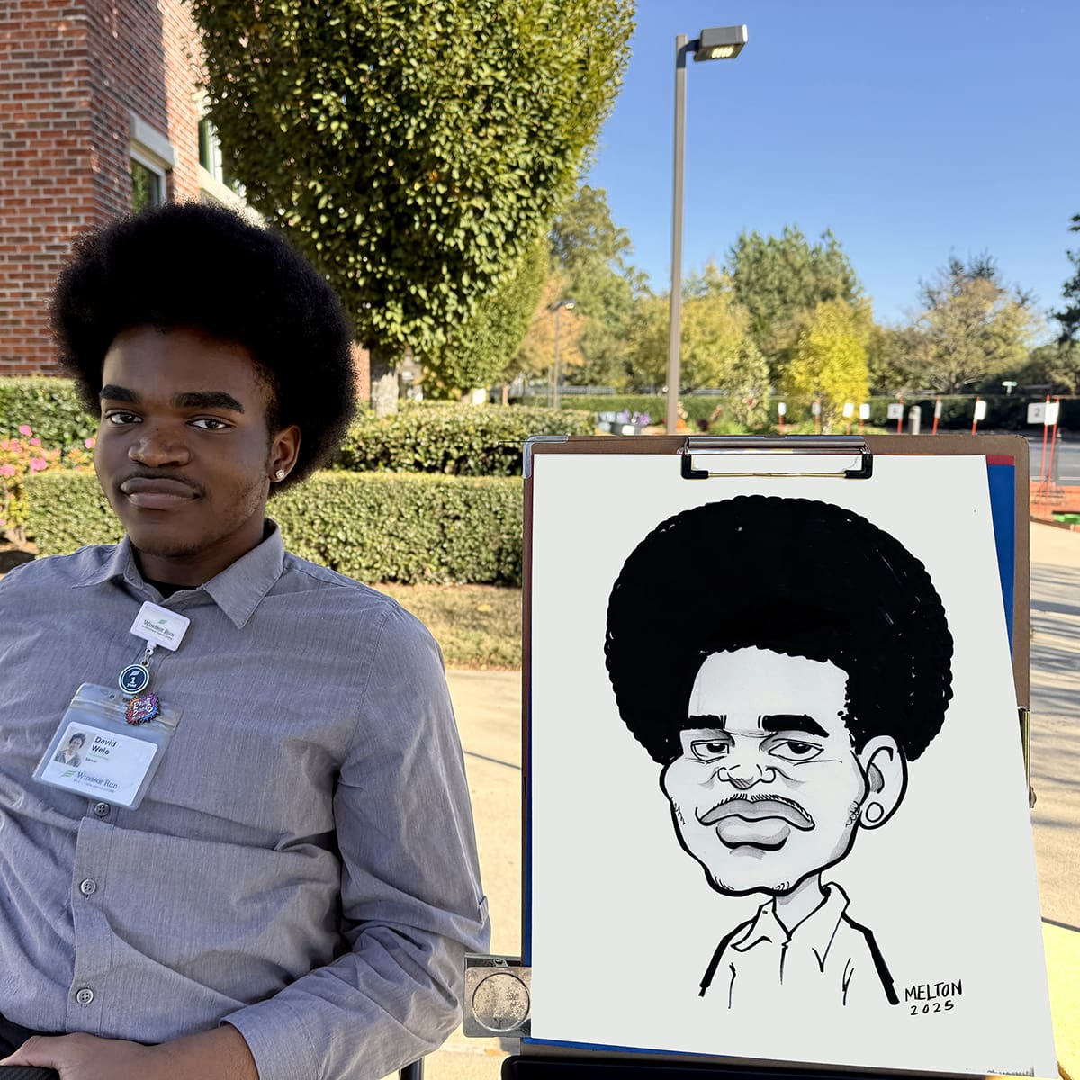 a young man posing with his funny caricature